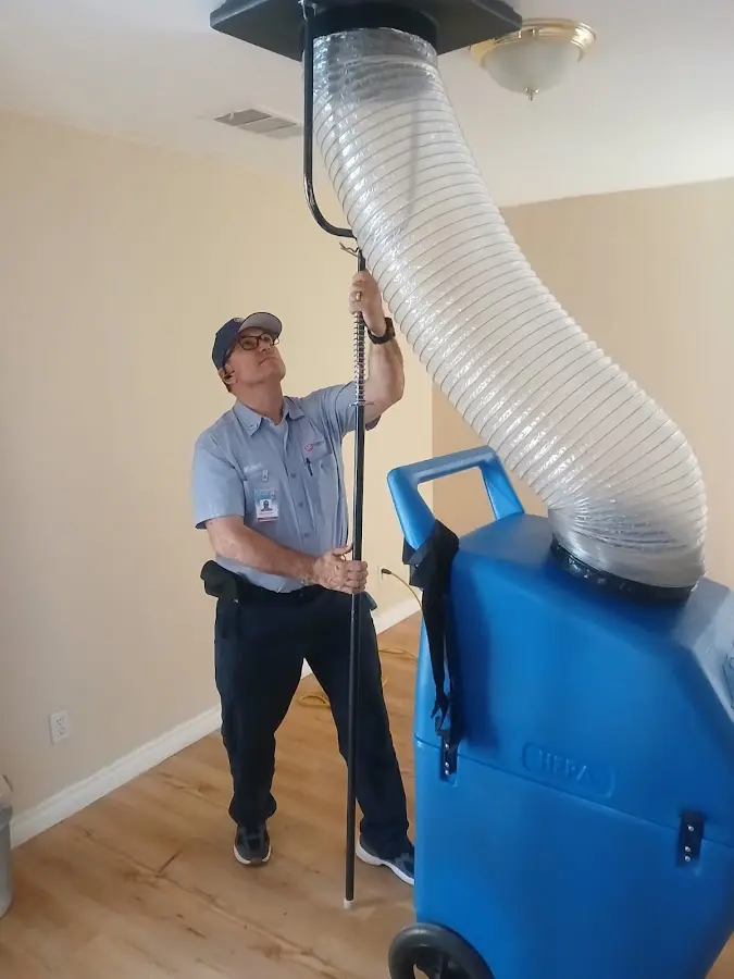 Furnace Tune-Up technician using HEPA equipment in Braselton